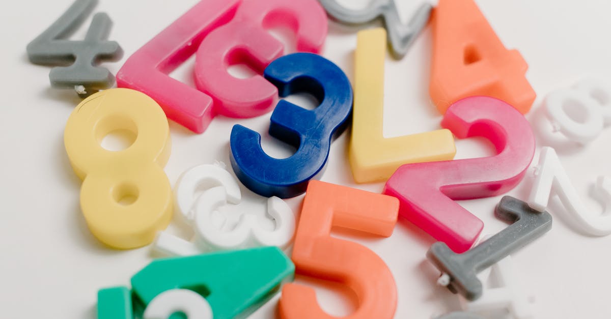 Vibrant plastic numbers scattered on a white background, ideal for educational themes.